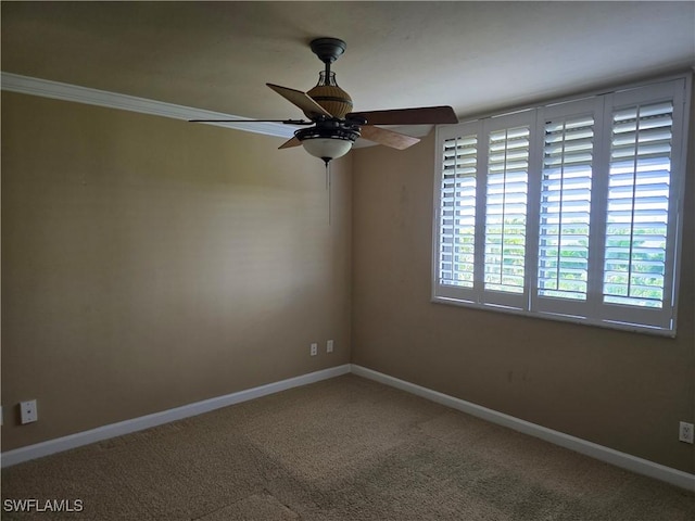 spare room with ornamental molding, ceiling fan, and carpet flooring