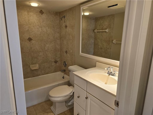 full bathroom featuring tiled shower / bath combo, vanity, tile patterned flooring, and toilet