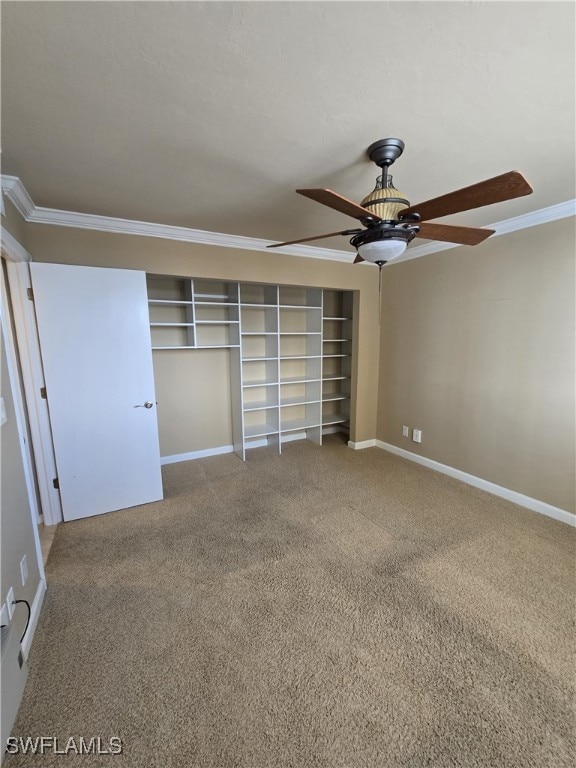 unfurnished bedroom with crown molding, carpet flooring, and ceiling fan