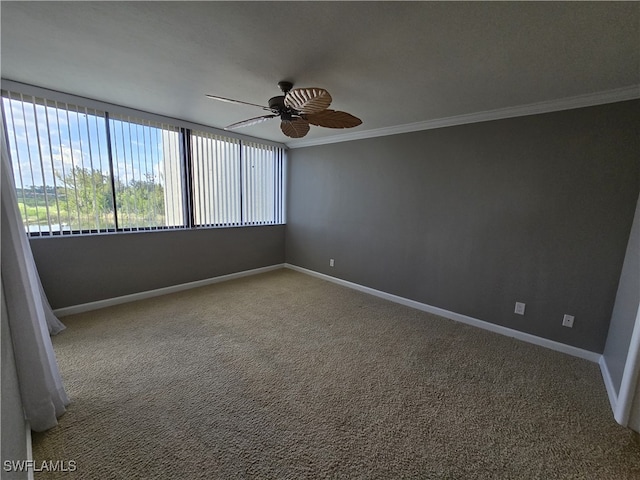 spare room featuring crown molding, ceiling fan, and carpet