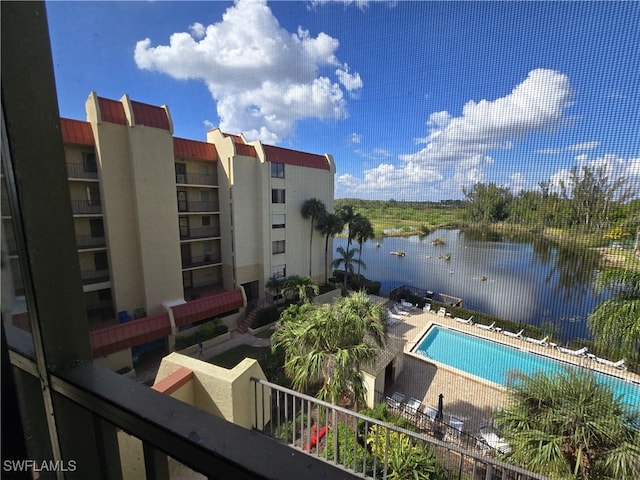 view of swimming pool with a water view and a patio area