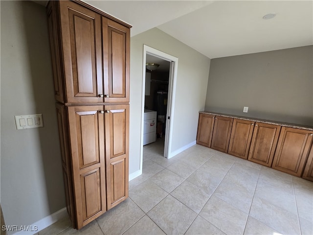 interior space with washer / clothes dryer and light tile patterned flooring