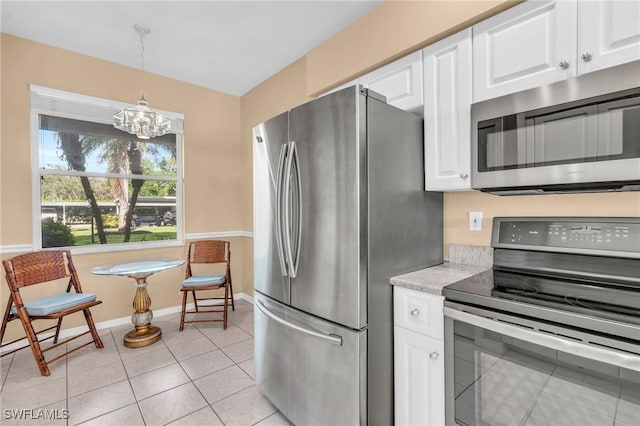 kitchen featuring stainless steel appliances, white cabinets, light tile patterned flooring, and pendant lighting