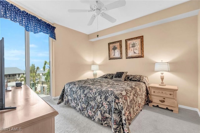 bedroom with access to exterior, light carpet, baseboards, and a ceiling fan