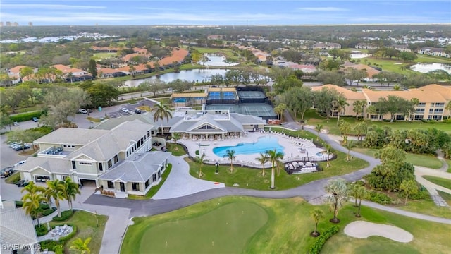 birds eye view of property featuring golf course view and a water view