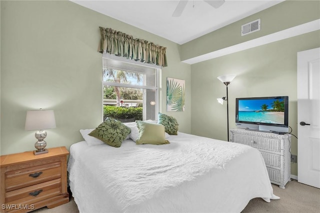 carpeted bedroom featuring visible vents and a ceiling fan