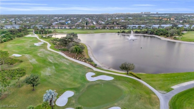 bird's eye view with a water view and view of golf course