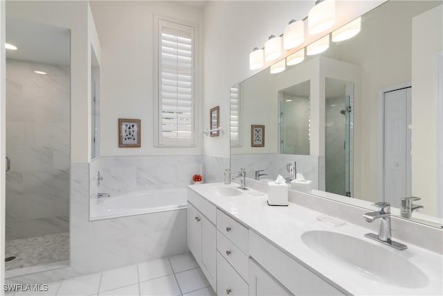 bathroom featuring tile patterned flooring, vanity, and separate shower and tub