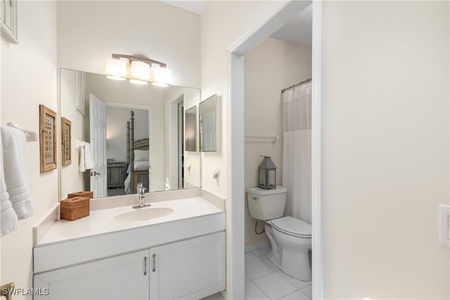 bathroom with tile patterned floors, vanity, toilet, and walk in shower