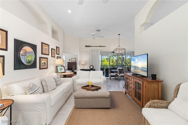 living room featuring ceiling fan with notable chandelier and light tile patterned floors