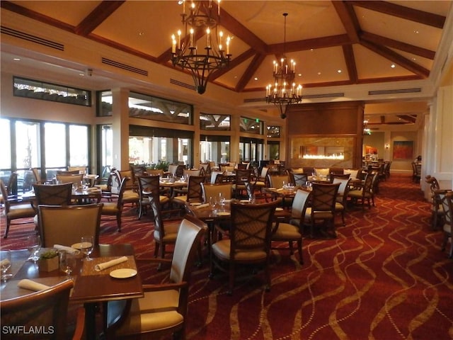 dining space with dark carpet, high vaulted ceiling, beamed ceiling, and a notable chandelier