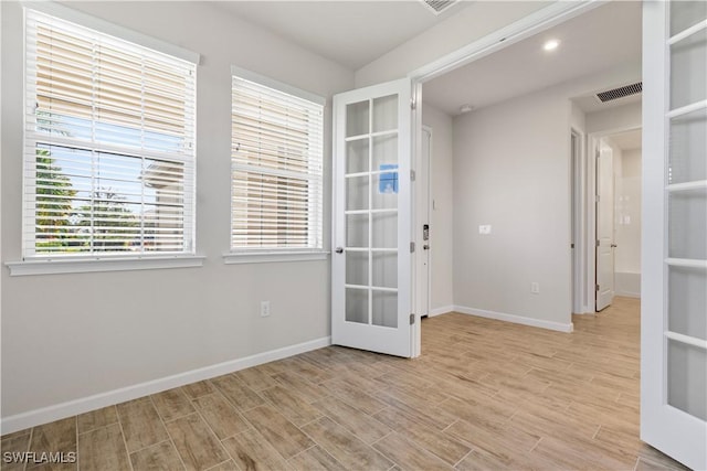 unfurnished room featuring french doors