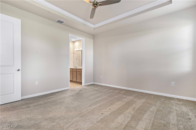 carpeted spare room featuring ceiling fan, crown molding, and a raised ceiling