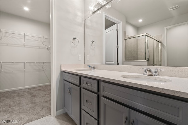 bathroom with vanity, tile patterned floors, and walk in shower