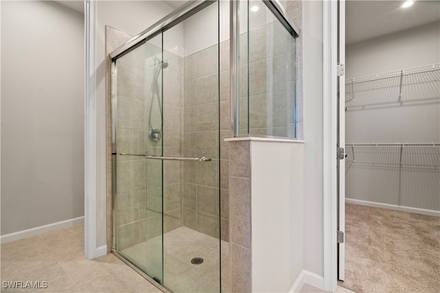 bathroom with a shower with door