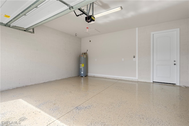 garage featuring electric water heater and a garage door opener