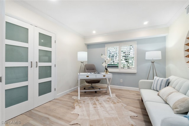 home office with crown molding and light hardwood / wood-style flooring