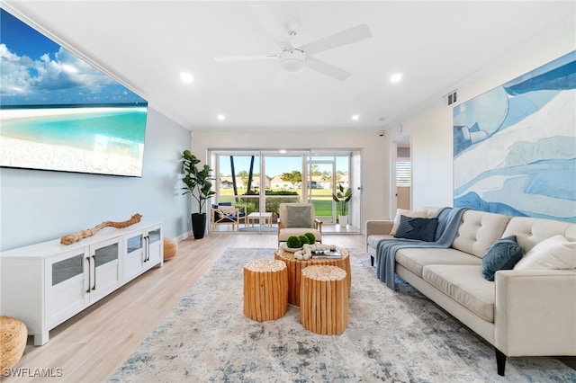 living room with light hardwood / wood-style floors and ceiling fan