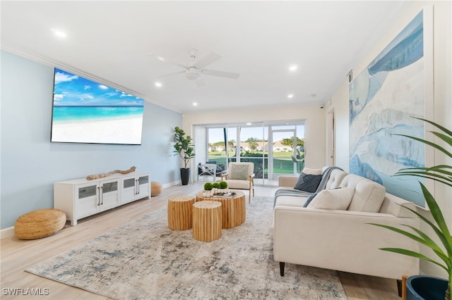 living room featuring hardwood / wood-style flooring, ceiling fan, and ornamental molding