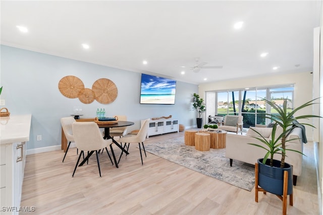 living room with ceiling fan and light hardwood / wood-style floors