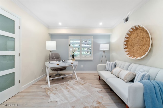 office area with light hardwood / wood-style floors and ornamental molding