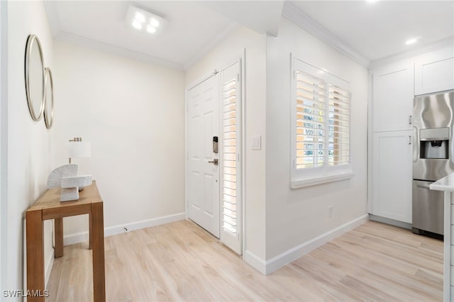 entryway featuring ornamental molding and light hardwood / wood-style flooring