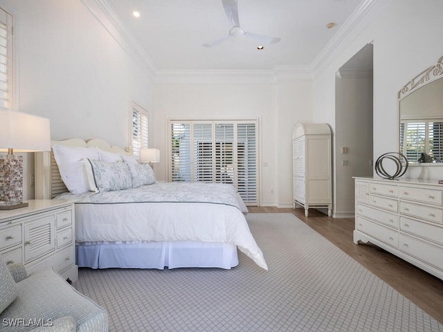 bedroom featuring ceiling fan, crown molding, and dark wood-type flooring