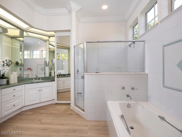 bathroom featuring hardwood / wood-style floors, independent shower and bath, a wealth of natural light, and crown molding