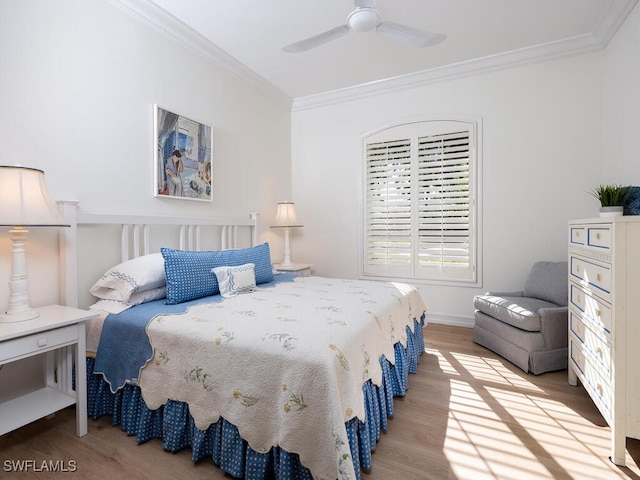 bedroom with hardwood / wood-style floors, ceiling fan, and ornamental molding