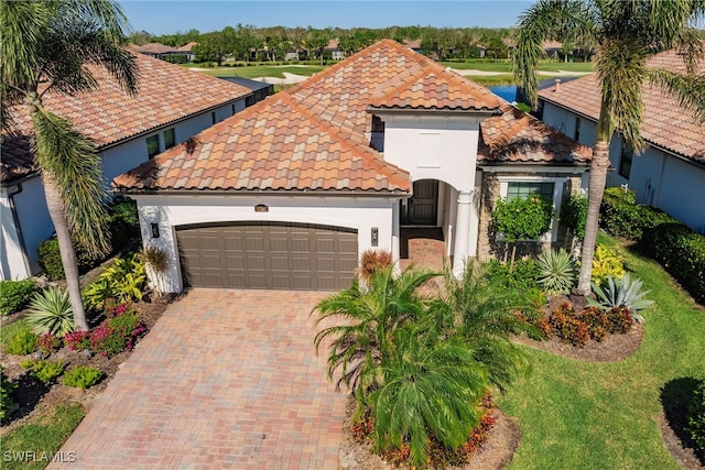 mediterranean / spanish house featuring a garage