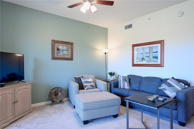 carpeted living room with ceiling fan