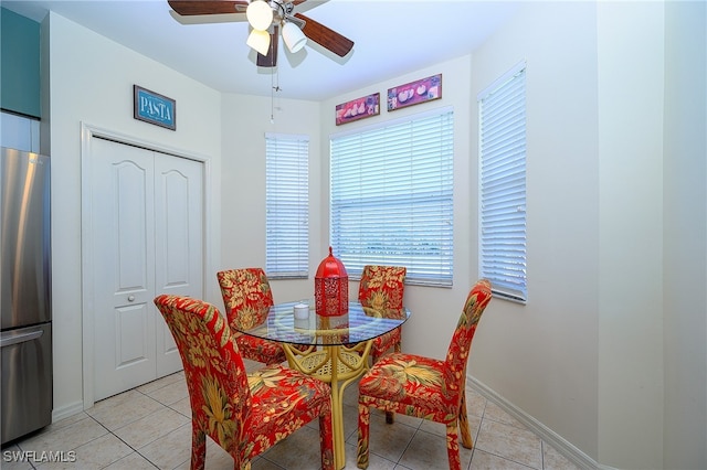 dining room with ceiling fan and light tile patterned flooring