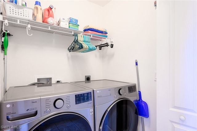 clothes washing area featuring independent washer and dryer