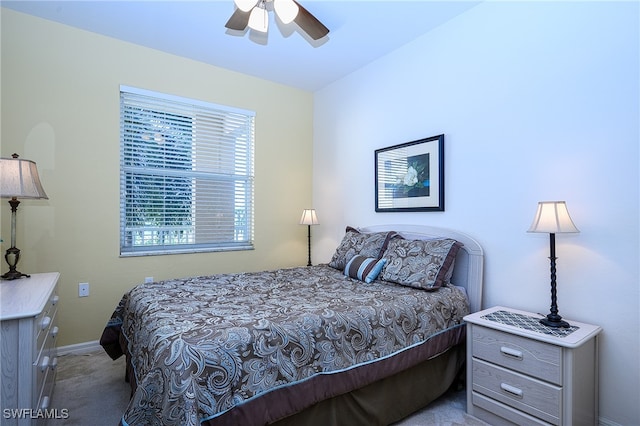 bedroom featuring ceiling fan and light carpet