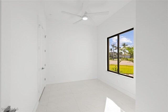 unfurnished room featuring ceiling fan and a healthy amount of sunlight