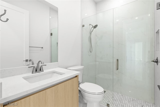 bathroom with vanity, toilet, and an enclosed shower