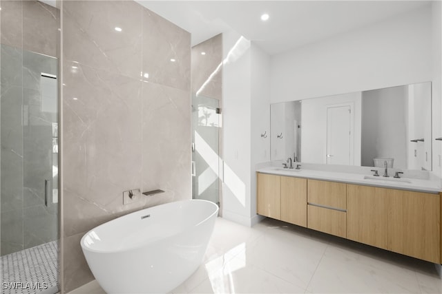 bathroom with vanity, tile walls, and independent shower and bath