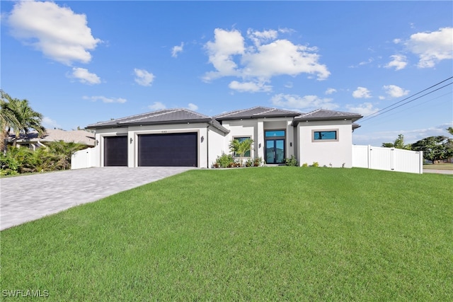 prairie-style home with a garage and a front yard