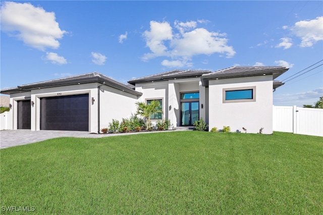 prairie-style home with a garage and a front lawn