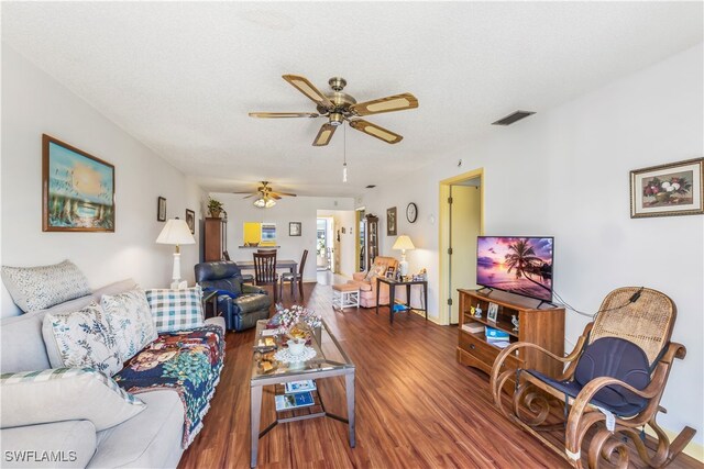 living room with ceiling fan, hardwood / wood-style floors, and a textured ceiling