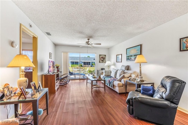 6842 Bogey Dr, Fort Myers, FL 33919 - living room with a ceiling fan, a textured ceiling, and wood finished floors