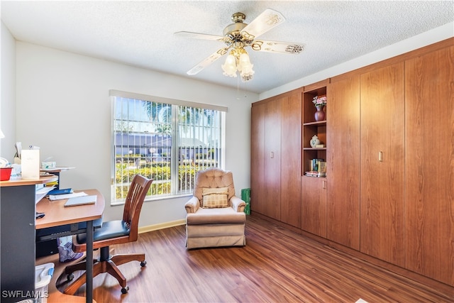 office with hardwood / wood-style floors, ceiling fan, and a textured ceiling