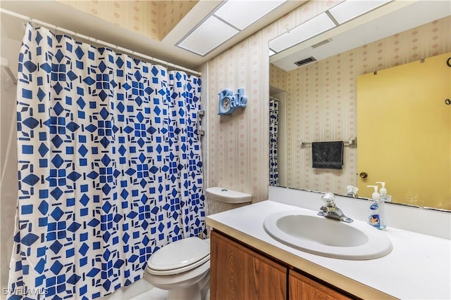 6842 Bogey Dr, Fort Myers, FL 33919 - full bathroom with wallpapered walls, toilet, vanity, and a shower with shower curtain