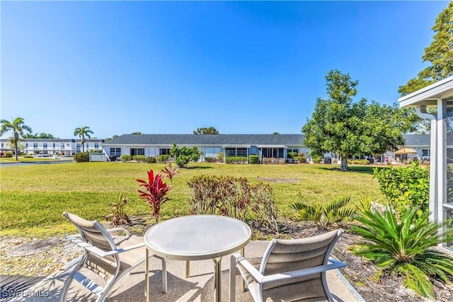 6842 Bogey Dr, Fort Myers, FL 33919 - view of green lawn with a patio area