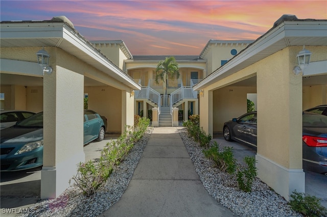 property exterior at dusk featuring a carport