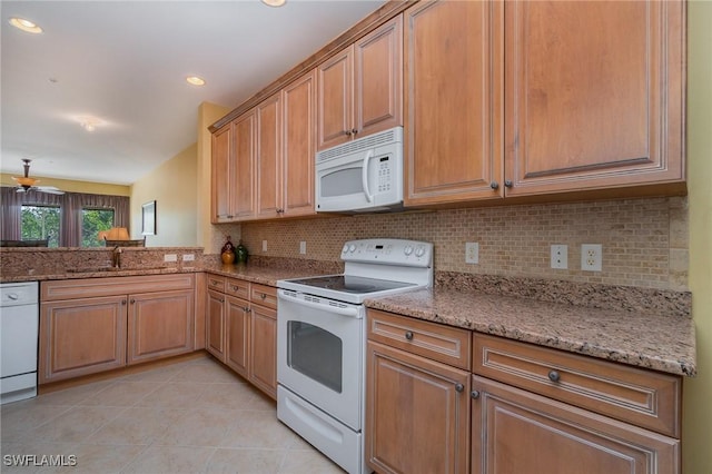 14531 Abaco Lakes Dr Unit 103, Fort Myers, FL 33908 - kitchen with white appliances, light tile patterned flooring, backsplash, light stone countertops, and recessed lighting