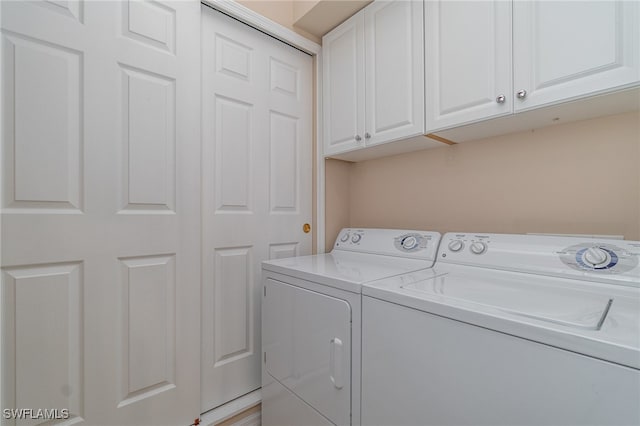 laundry room with cabinets and washer and dryer