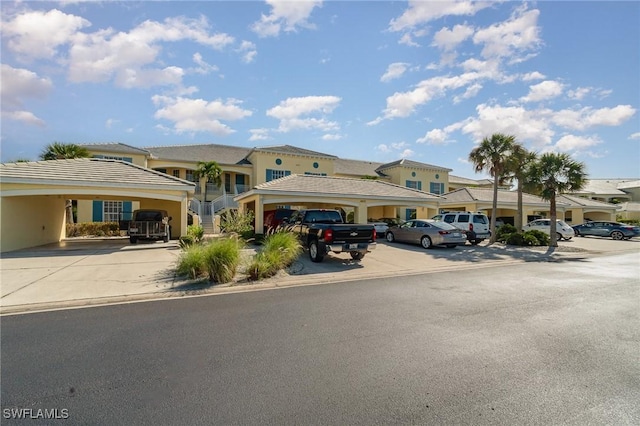 14531 Abaco Lakes Dr Unit 103, Fort Myers, FL 33908 - view of property featuring uncovered parking