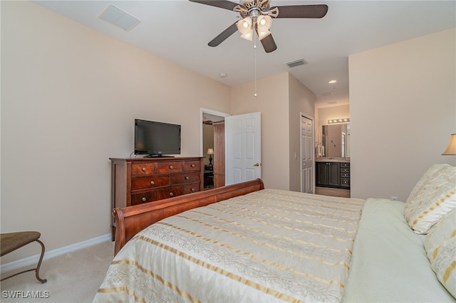 bedroom featuring ensuite bath, ceiling fan, a closet, and light carpet