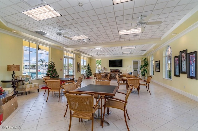 14531 Abaco Lakes Dr Unit 103, Fort Myers, FL 33908 - dining area with a ceiling fan, crown molding, light tile patterned flooring, and a raised ceiling